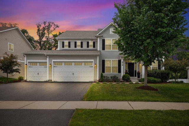 819 Heatherfield Cir, Naperville, IL 60565 - view of front facade featuring asphalt driveway, a lawn, and a garage
