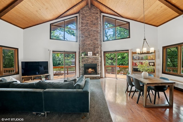 11214 Halma Ln, Woodstock, IL 60098 - living room featuring a wooden ceiling with exposed beams, hardwood / wood-style floors, high vaulted ceiling, and a stone fireplace