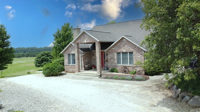 1897 N 2500 E Rd, Watseka, IL 60970 - view of front facade with brick siding, a chimney, and a shingled roof