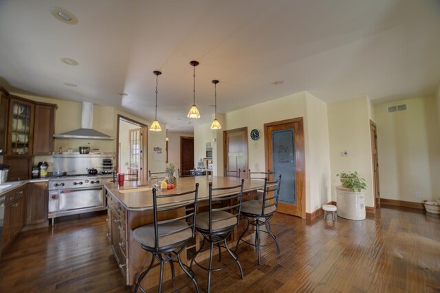 1897 N 2500 E Rd, Watseka, IL 60970 - kitchen with wall chimney exhaust hood, dark wood finished floors, a kitchen island, and light countertops