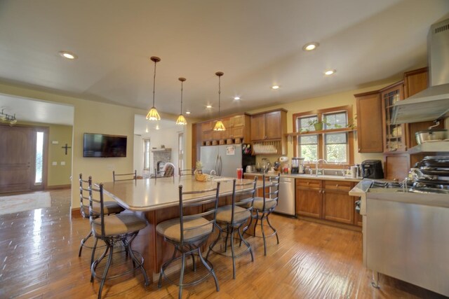 1897 N 2500 E Rd, Watseka, IL 60970 - kitchen featuring appliances with stainless steel finishes, a kitchen breakfast bar, light countertops, brown cabinets, and recessed lighting
