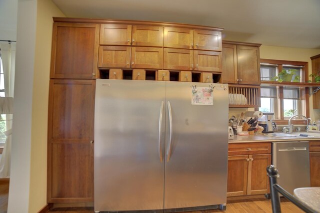 1897 N 2500 E Rd, Watseka, IL 60970 - kitchen with appliances with stainless steel finishes, light wood-style floors, light countertops, and brown cabinets