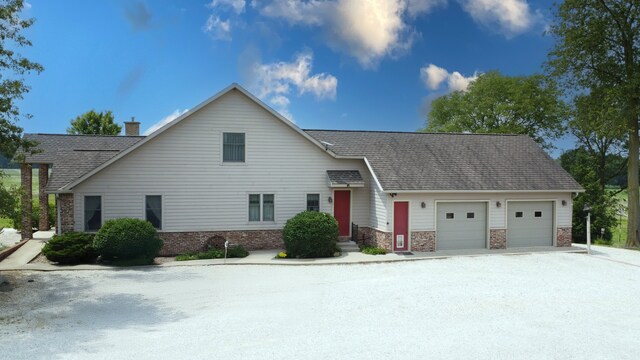 1897 N 2500 E Rd, Watseka, IL 60970 - view of front of home featuring a garage, brick siding, and a chimney