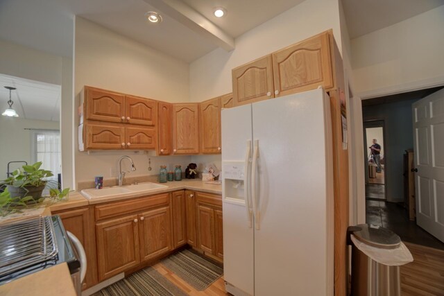 1897 N 2500 E Rd, Watseka, IL 60970 - kitchen featuring white fridge with ice dispenser, range, light countertops, wood finished floors, and beam ceiling
