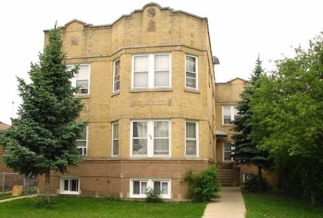 5851 W Eastwood Ave, Chicago, IL 60630 - view of front facade featuring a front lawn and brick siding