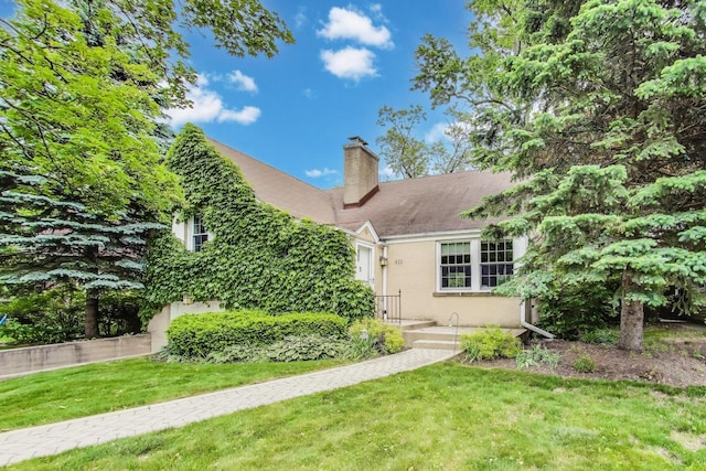 433 S Dunton Ave, Arlington Heights, IL 60005 - obstructed view of property with a chimney, a front yard, and an attached garage