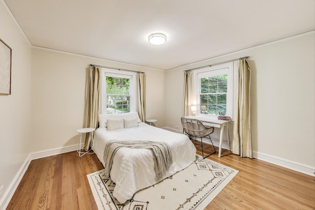 433 S Dunton Ave, Arlington Heights, IL 60005 - bedroom with light wood-style floors, baseboards, and crown molding