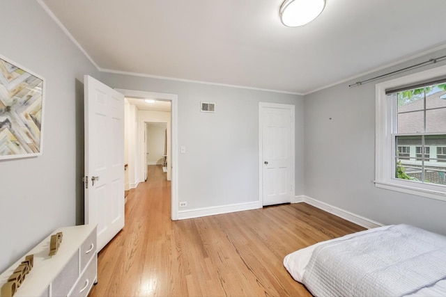 433 S Dunton Ave, Arlington Heights, IL 60005 - bedroom with light wood-style floors, ornamental molding, and baseboards