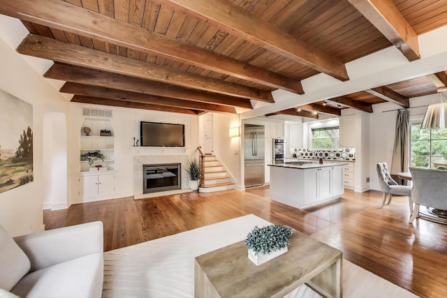 433 S Dunton Ave, Arlington Heights, IL 60005 - living area with wood ceiling with exposed beams, light wood-style floors, healthy amount of natural light, a glass covered fireplace, and baseboards