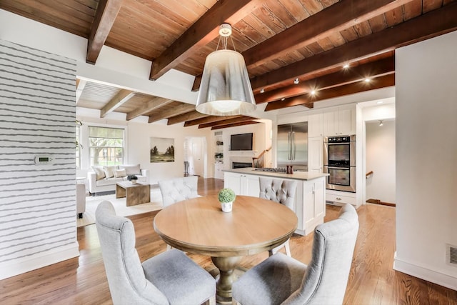 433 S Dunton Ave, Arlington Heights, IL 60005 - dining area featuring wooden ceiling with exposed beams, light wood-type flooring, and baseboards