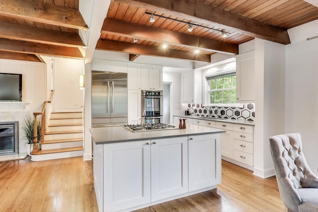 433 S Dunton Ave, Arlington Heights, IL 60005 - kitchen with stainless steel appliances, wood ceiling with exposed beams, white cabinets, light wood-type flooring, and decorative backsplash