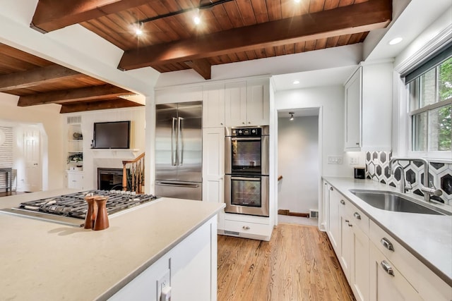 433 S Dunton Ave, Arlington Heights, IL 60005 - kitchen featuring stainless steel appliances, a sink, wood ceiling with exposed beams, light countertops, and light wood-style floors