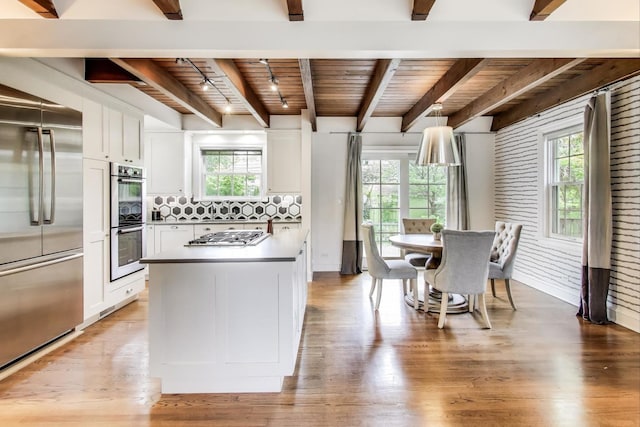 433 S Dunton Ave, Arlington Heights, IL 60005 - kitchen with appliances with stainless steel finishes, wooden ceiling with exposed beams, white cabinets, light wood-style floors, and tasteful backsplash