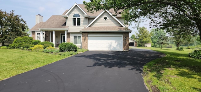 23243 S Volbrecht Rd, Crete, IL 60417 - view of front of house featuring asphalt driveway, brick siding, a front lawn, and a chimney