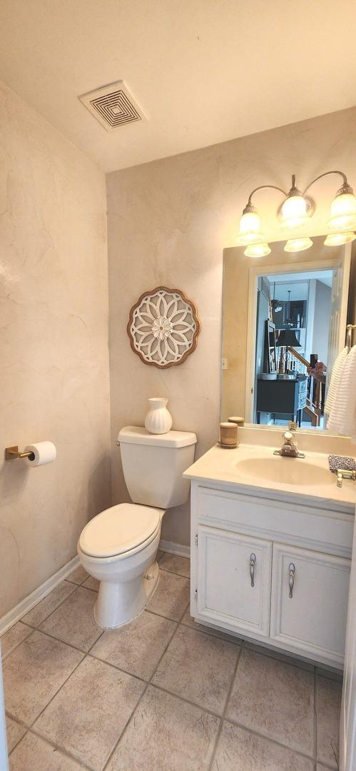 23243 S Volbrecht Rd, Crete, IL 60417 - half bath with toilet, vanity, tile patterned flooring, and baseboards