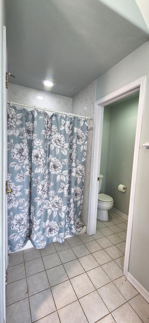 23243 S Volbrecht Rd, Crete, IL 60417 - full bathroom featuring toilet, tile patterned floors, and a shower with curtain