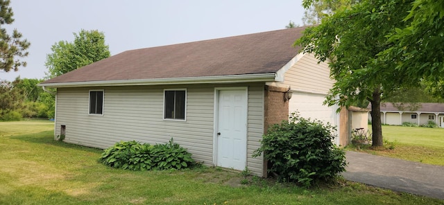 23243 S Volbrecht Rd, Crete, IL 60417 - view of property exterior with an outdoor structure, a garage, a yard, and roof with shingles