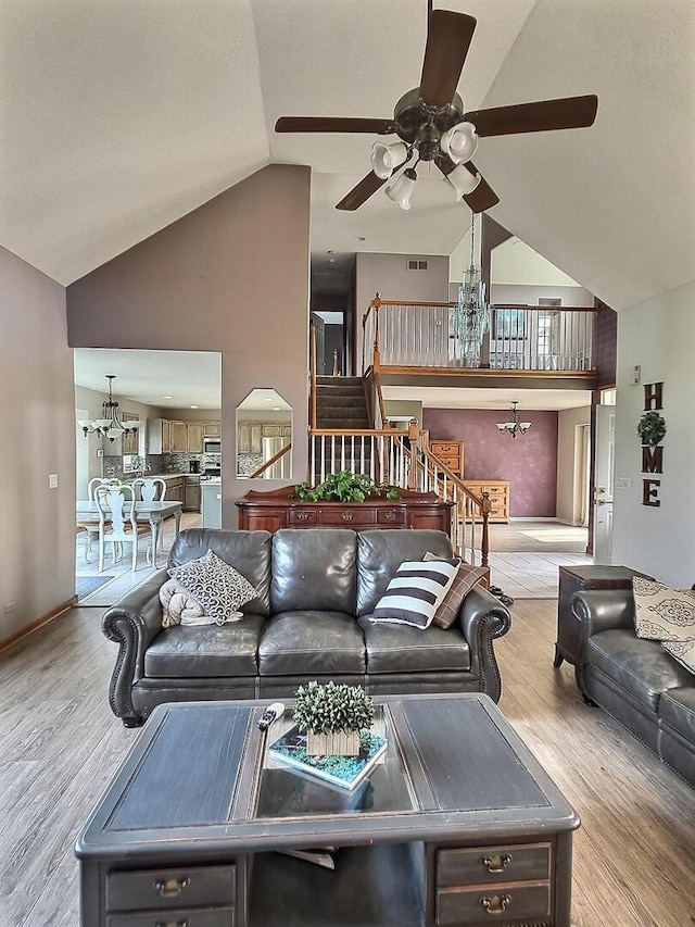 23243 S Volbrecht Rd, Crete, IL 60417 - living area featuring ceiling fan, a chandelier, wood finished floors, high vaulted ceiling, and stairs