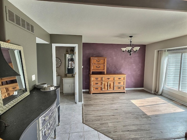 23243 S Volbrecht Rd, Crete, IL 60417 - dining room featuring a chandelier, light tile patterned floors, and baseboards