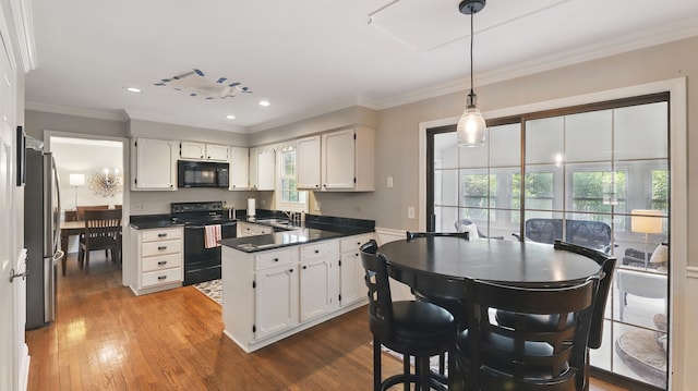 533 Warwick Dr, Naperville, IL 60565 - kitchen featuring black appliances, white cabinets, wood finished floors, dark countertops, and crown molding