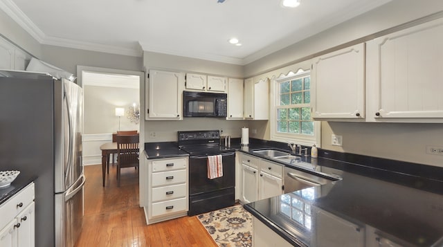 533 Warwick Dr, Naperville, IL 60565 - kitchen with black appliances, dark countertops, light wood-style floors, ornamental molding, and a sink