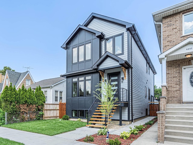 4845 N Mcvicker Ave, Chicago, IL 60630 - view of front of house with stairs and board and batten siding