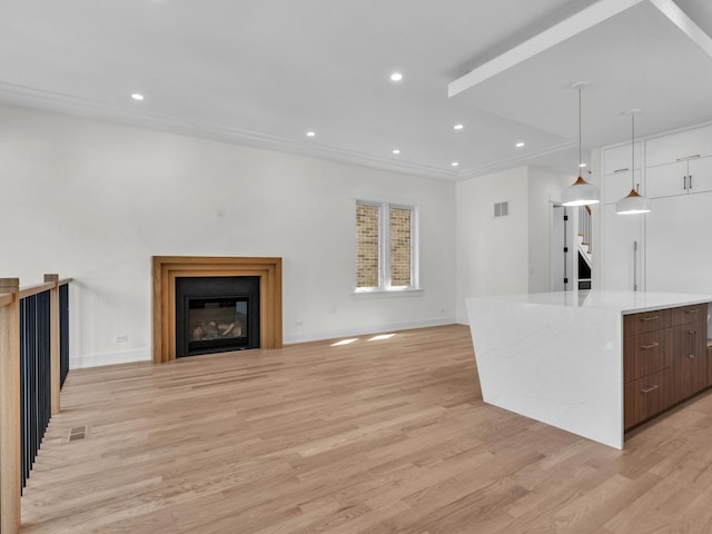 4845 N Mcvicker Ave, Chicago, IL 60630 - unfurnished living room with light wood finished floors, a glass covered fireplace, and recessed lighting