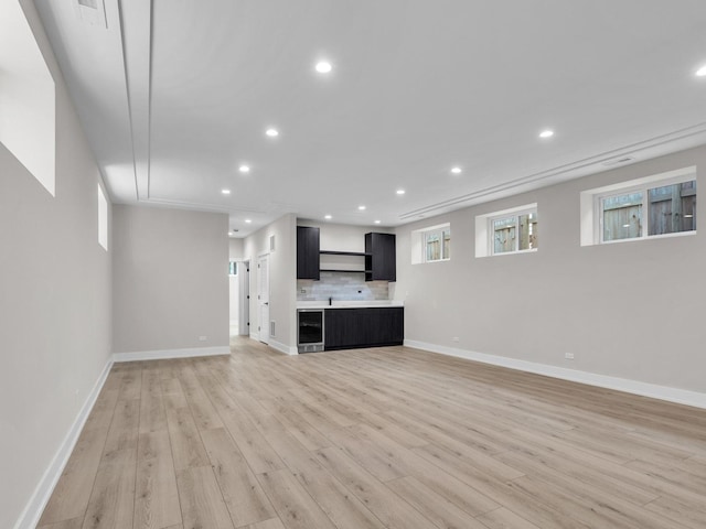 4845 N Mcvicker Ave, Chicago, IL 60630 - unfurnished living room featuring wine cooler, light wood finished floors, and recessed lighting
