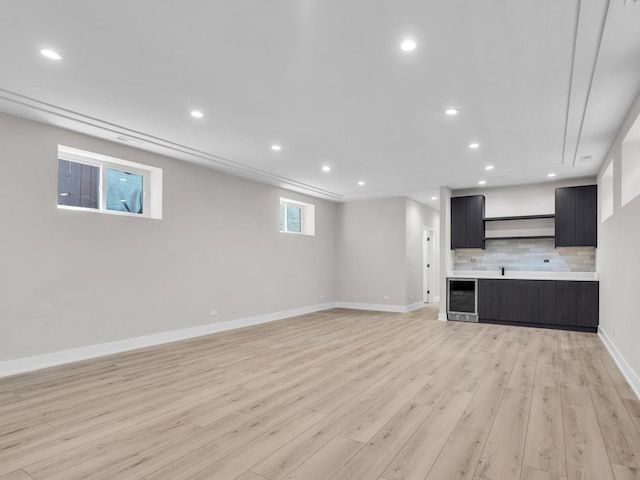 4845 N Mcvicker Ave, Chicago, IL 60630 - unfurnished living room featuring wine cooler, light wood-style flooring, and recessed lighting