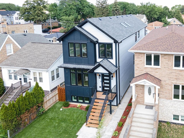 4845 N Mcvicker Ave, Chicago, IL 60630 - view of front of house with board and batten siding, stairway, brick siding, and a residential view
