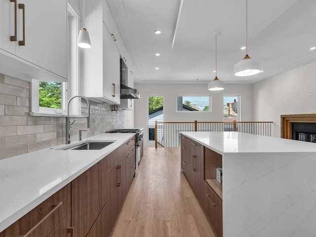 4845 N Mcvicker Ave, Chicago, IL 60630 - kitchen featuring modern cabinets, light wood-type flooring, high end stove, a center island, and white cabinets