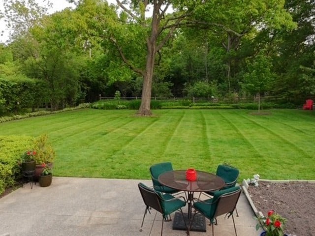 811 Redwood Ln, Glenview, IL 60025 - view of grassy yard featuring a patio and outdoor dining area
