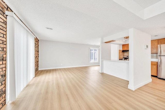 9830 Sayre Ave Unit 7, Chicago Ridge, IL 60415 - unfurnished living room with light wood-type flooring, a textured ceiling, a fireplace, and baseboards