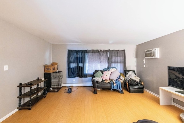 1619 N 35th Ave, Melrose Park, IL 60160 - living area with a wall unit AC, wood finished floors, baseboards, and a baseboard heating unit