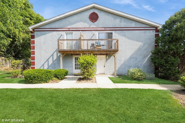 1141 Greenwood Cir Unit 7F, Woodstock, IL 60098 - view of front of property featuring a front lawn, stucco siding, and a balcony