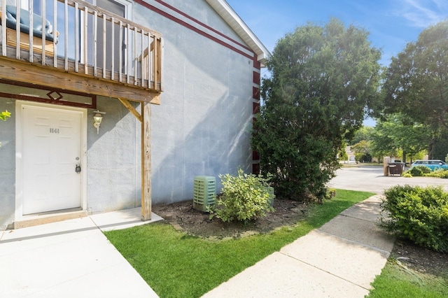 1141 Greenwood Cir Unit 7F, Woodstock, IL 60098 - view of exterior entry with stucco siding