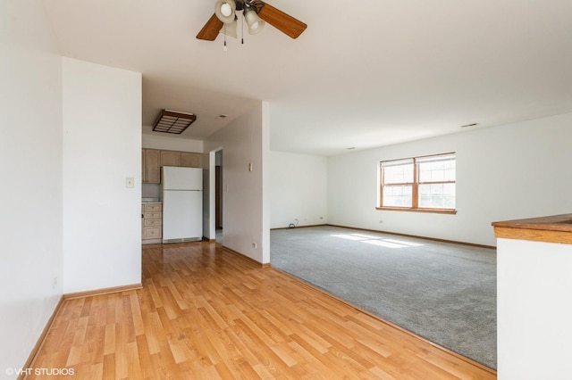 1141 Greenwood Cir Unit 7F, Woodstock, IL 60098 - unfurnished living room with a ceiling fan, light wood-style flooring, and light colored carpet