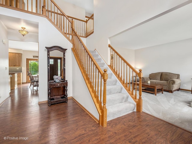 1665 Whispering Oaks Ct, West Chicago, IL 60185 - staircase with wood finished floors and a towering ceiling