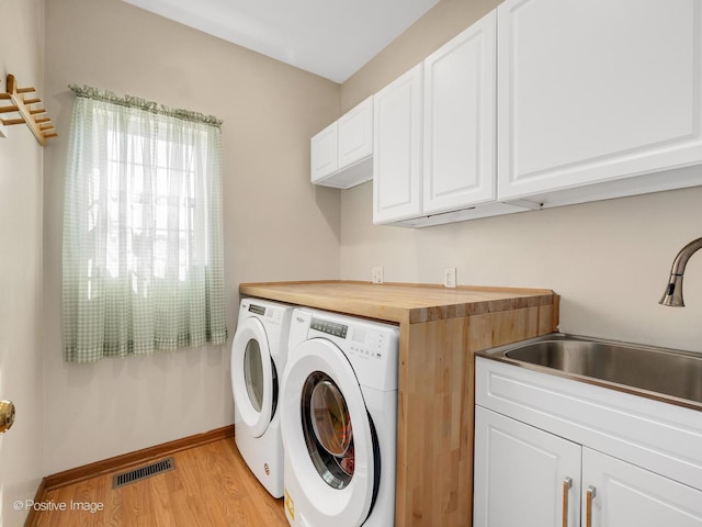 1665 Whispering Oaks Ct, West Chicago, IL 60185 - washroom featuring washer and clothes dryer, cabinet space, and light wood-type flooring