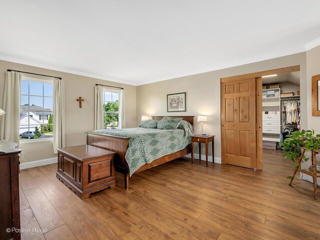 1665 Whispering Oaks Ct, West Chicago, IL 60185 - bedroom with light wood-style flooring, crown molding, and a closet