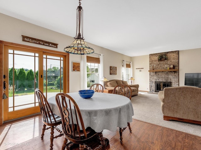 1665 Whispering Oaks Ct, West Chicago, IL 60185 - dining room featuring wood finished floors and a fireplace