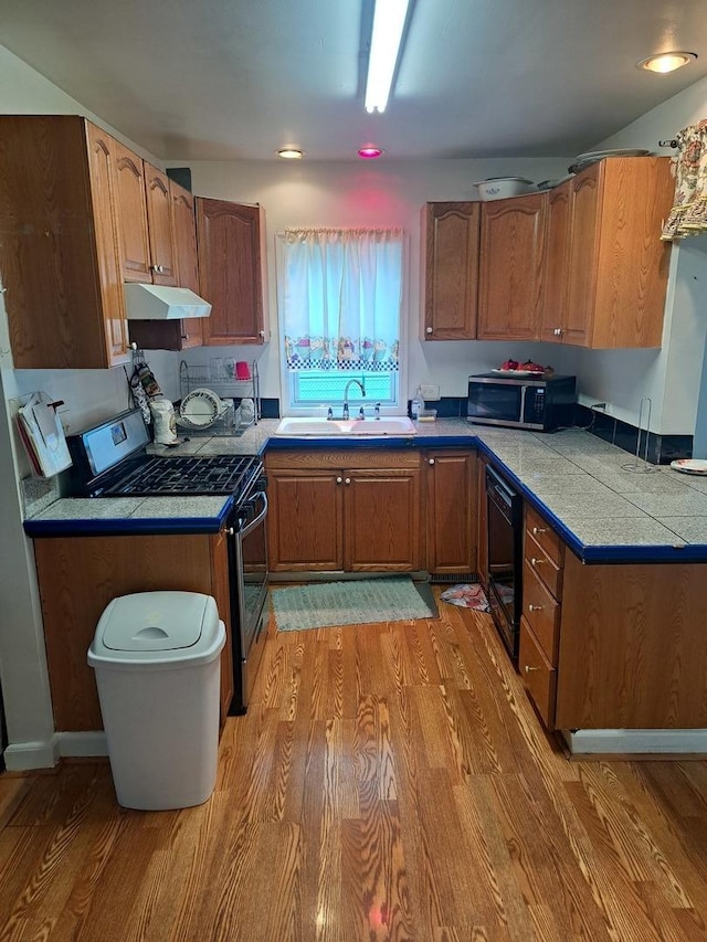 1403 Lacey Ave, Lisle, IL 60532 - kitchen with a sink, appliances with stainless steel finishes, light wood-style floors, and brown cabinetry