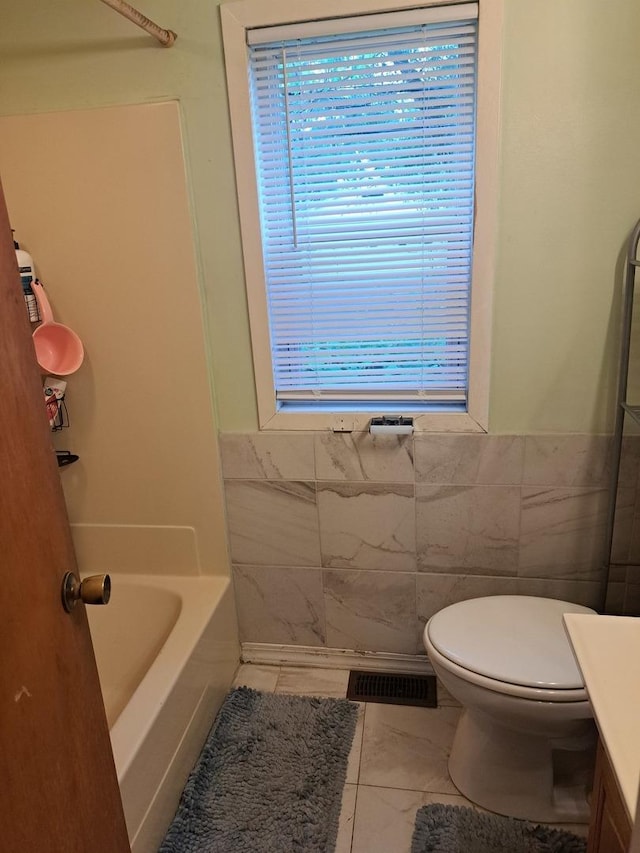 1403 Lacey Ave, Lisle, IL 60532 - bathroom with tile walls, vanity, toilet, and a wainscoted wall