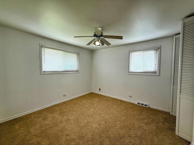 572 N Emroy Ave, Elmhurst, IL 60126 - unfurnished bedroom featuring multiple windows, carpet flooring, a closet, and ceiling fan