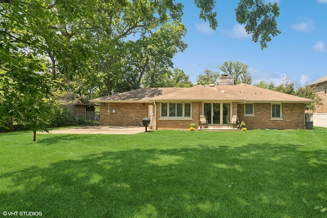 231 N Forest Ct, Addison, IL 60101 - back of house featuring a patio area, a chimney, and brick siding
