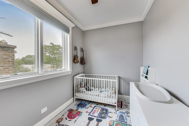 2709 W Bryn Mawr Ave Unit 4, Chicago, IL 60659 - bedroom featuring a crib, crown molding, baseboards, and ceiling fan