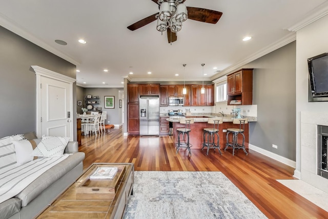 2709 W Bryn Mawr Ave Unit 4, Chicago, IL 60659 - living room with ceiling fan, light wood-style floors, baseboards, ornamental molding, and recessed lighting