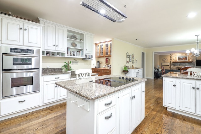 1925 Kentwood Ct, Darien, IL 60561 - kitchen with black electric stovetop, stainless steel double oven, open shelves, a kitchen island, and wood finished floors