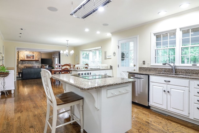 1925 Kentwood Ct, Darien, IL 60561 - kitchen with dishwasher, black electric cooktop, ornamental molding, light stone countertops, and a breakfast bar area