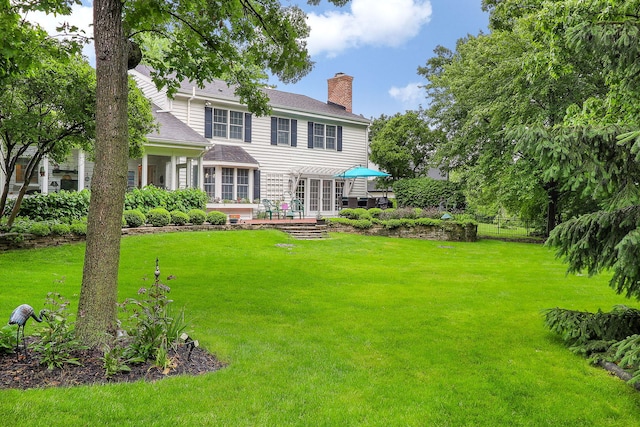 1925 Kentwood Ct, Darien, IL 60561 - rear view of property featuring a chimney, a yard, a shingled roof, and a patio